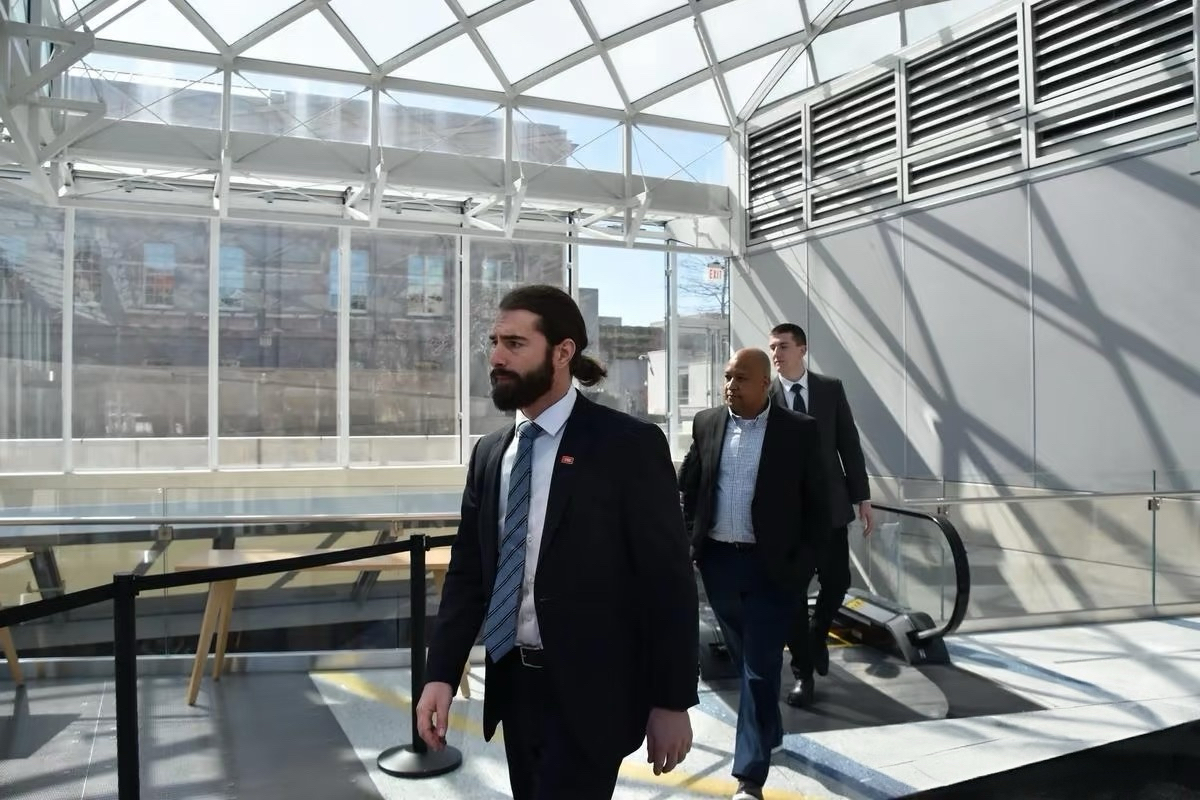 Professional security personnel escorting a client through a commercial property